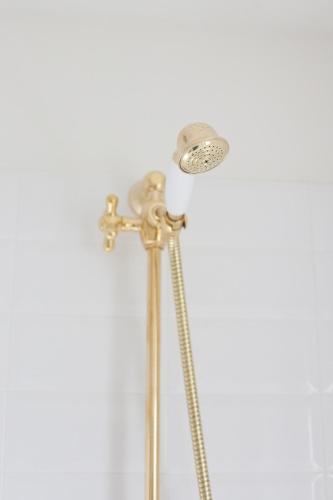 a shower with a shower head and a shower head at Alessia's Place in Como
