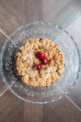 a cookie in a glass bowl with two cherries on it at Alessia's Place in Como