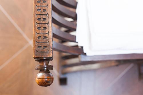 a wooden leg of a bench with the wordoria on it at Alessia's Place in Como