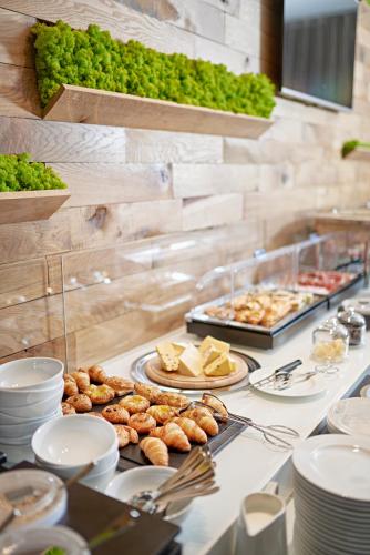 a buffet with plates of food on a table at Theatre Hotel in Olomouc