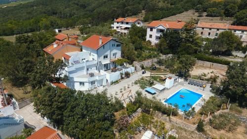 an aerial view of a house with a swimming pool at Apartmani Mihaela II in Baška