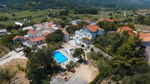 an aerial view of a house with a swimming pool at Apartmani M in Baška
