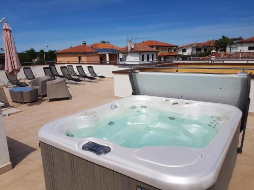a jacuzzi tub sitting on a patio with an umbrella at Villa Alpa in Umag