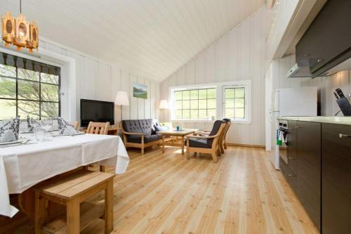 a kitchen and a living room with a bed in a room at Rondane Hytter og Leiligheter in Otta