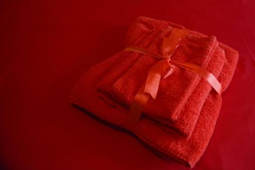 un regalo rojo con un arco en un fondo rojo en My Home In Olympus, en Pyrgetós