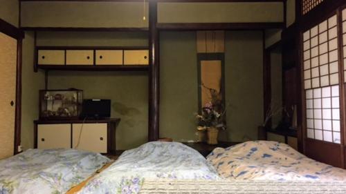 Ένα ή περισσότερα κρεβάτια σε δωμάτιο στο International Guest House Tani House