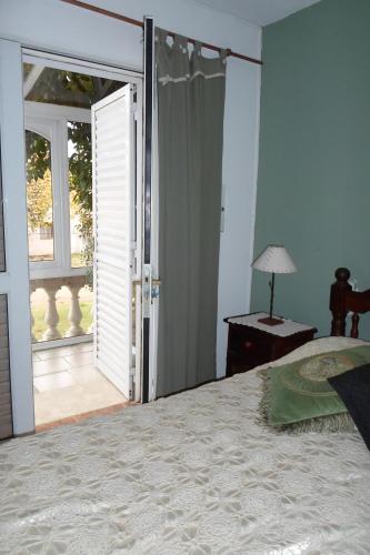 a bedroom with a bed and an open door at La Casona de Susana in Colón