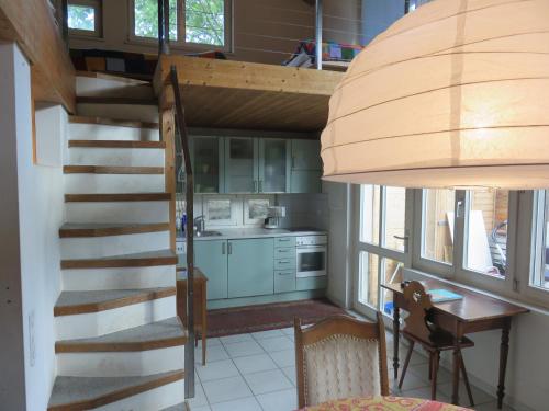 a kitchen with a spiral staircase in a tiny house at BnB Erlach in Erlach