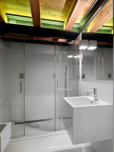 a bathroom with a glass shower and a sink at Le Coffret in Saint Marcel