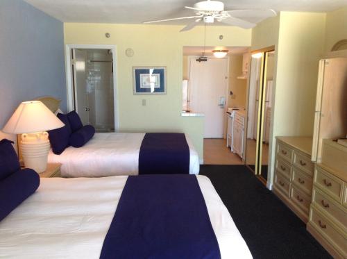 a hotel room with two beds and a bathroom at Shoreline Island Resort - Exclusively Adult in St Pete Beach
