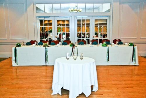 a set of tables in a room with chairs at Ramada by Wyndham Seekonk Providence Area in Seekonk