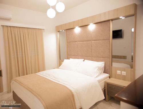 a hotel room with a bed and a bathroom at Ideal House in Parga