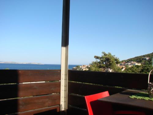 a balcony with a table and a view of the ocean at AnnaDes Apartments & Studios Chios in Karfas