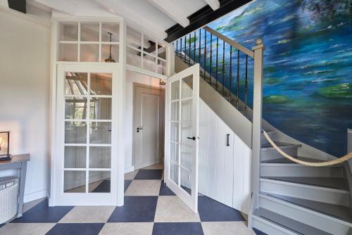 a staircase in a house with a painting on the wall at Villa Magnolia in Oostkapelle