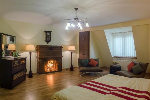 a bedroom with a bed and a fire place at Penthouse Apartment with Panoramic Views in Tbilisi City