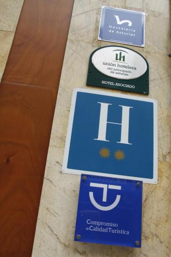 three signs for the hilbert hilbert international airport at Hotel Alda Centro Oviedo in Oviedo