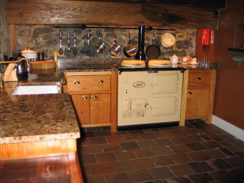 a kitchen with a sink and a counter with utensils at Clenaghans in Moira
