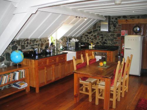 a kitchen with a wooden table and a dining room at Clenaghans in Moira