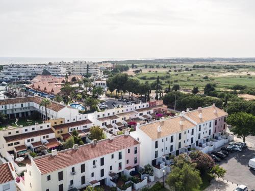an aerial view of a town with white buildings at Mouraliz Apartments by HD PROPERTIES - Vilamoura Marina in Vilamoura