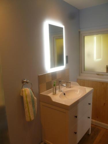 a bathroom with a sink and a mirror at The Nook @ Drop Anchor in Portishead