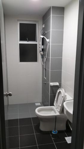 a bathroom with a toilet and a sink at The Aliff Residences in Johor Bahru