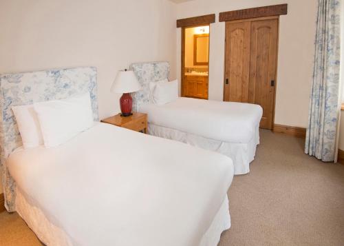 a hotel room with two beds and a lamp at The Arrabelle at Vail Square, a RockResort in Vail
