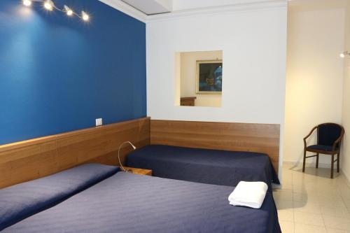 Postel nebo postele na pokoji v ubytování Hotel Viterbo Inn