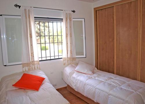 a bedroom with a bed and a window with a couch at La Casa De La Puebla in La Puebla de Montalbán