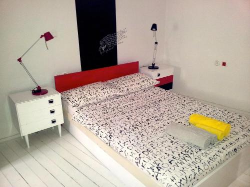 a bedroom with a bed with a red headboard and two lamps at Houses of Motovun in Motovun
