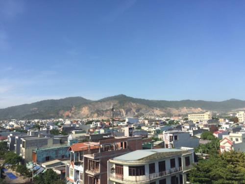 a city with buildings and mountains in the background at Bắc Nam Hotel in Da Nang