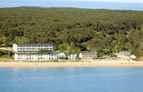 an aerial view of a house on the shore of the water at Horizons Beach Resort in North Truro