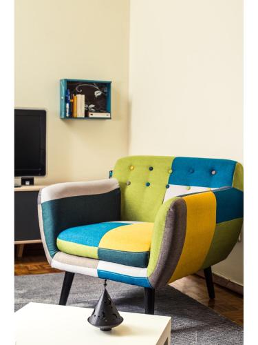 a living room with a couch and a chair at Downtown Shelter - Casa da Praça in Aveiro