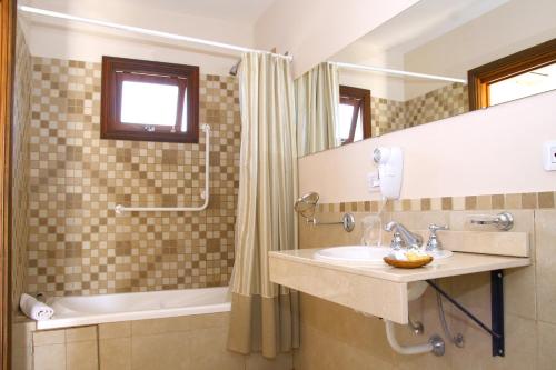 a bathroom with a sink and a shower and a tub at Solar del Pago in San Antonio de Areco