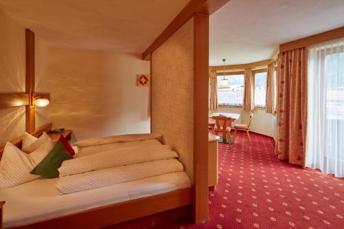 a hotel room with a bed and a table at Das Apartment Rief daheim beim Wanderprofi Adults Only in Tannheim