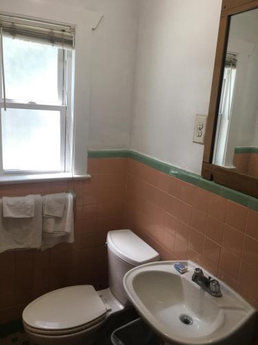 a bathroom with a toilet and a sink at Shelton Motel in Rio Grande