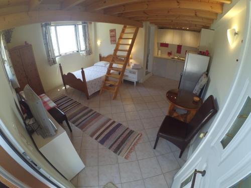 an overhead view of a room with a bed and a ladder at Kostas Walkers Point in Dafnáta