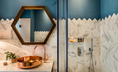 a bathroom with a copper sink and a shower at Nyx Chic Manor in Chania Town