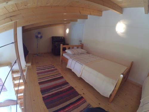 a bedroom with a bed and a rug in a room at Kostas Walkers Point in Dafnáta