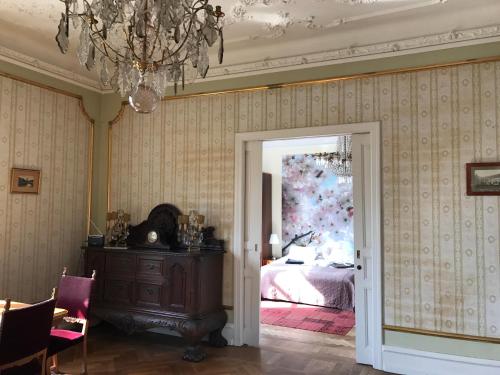 a bedroom with a bed and a chandelier at Gamla Stan Simrishamn in Simrishamn