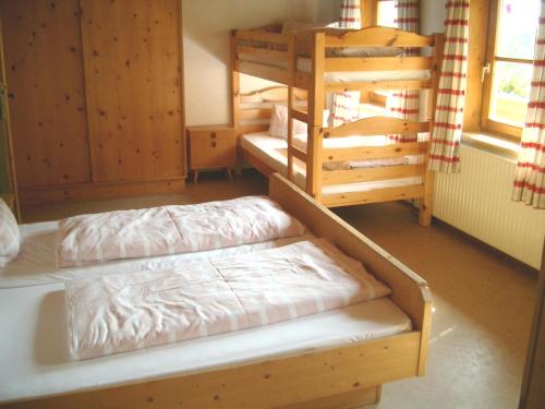 a room with two bunk beds and a window at Pension Steinerhof in Oberau