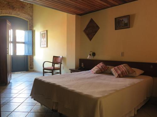 a bedroom with a large bed in a room at Pousada do Pilar in Salvador