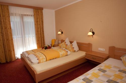 Habitación de hotel con 2 camas y ventana en Landhaus Zeller, en Fügenberg