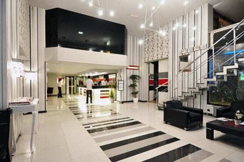 a lobby with a staircase in a building at North Point Hotel in Samsun
