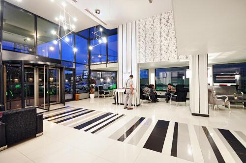 a man standing in the lobby of a building at North Point Hotel in Samsun