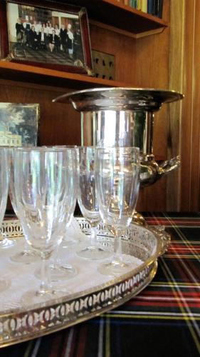 a group of wine glasses sitting on a table at Loch Ness Lodge Hotel in Drumnadrochit