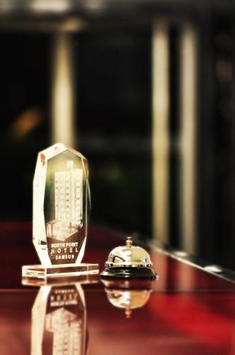 a model of a phone and a watch on a table at North Point Hotel in Samsun