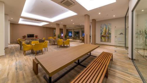 a dining room with a table and yellow chairs at Ada Julian Marmaris in Marmaris