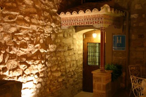 a room with a stone wall with a doorway at Hostal Santa María de Úbeda in Úbeda
