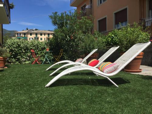 a white lawn chair with balls on the grass at Oasi Hotel in Levanto
