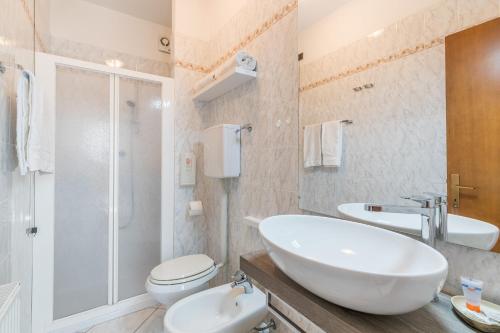 a bathroom with a sink and a toilet and a shower at B&B Casa Benamati by Kelly in Malcesine